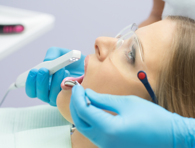 A patient getting her teeth examined.